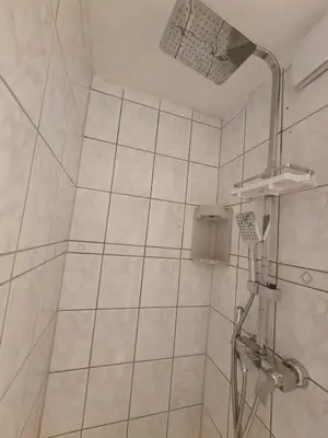 a white bathroom with a shower with a shower at Pause Nature N in La Calamine