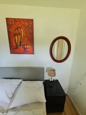 a bedroom with a bed and a mirror on the wall at Pause Nature N in La Calamine