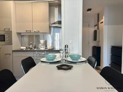 a kitchen with a table with two bowls on it at Le studio de la Cathédrale - Hypercentre avec balcon in Liège