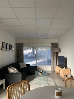 a living room with a couch and a table at Le Cabinet in Liège