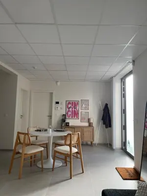 a living room with a table and chairs at Le Cabinet in Liège