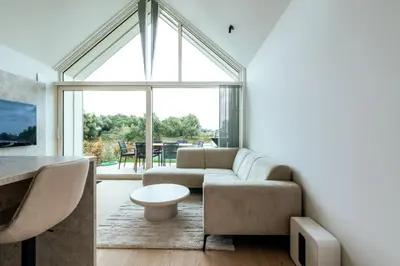 a living room with a couch and a table at Mase waterunits 6 & 7 in Maaseik