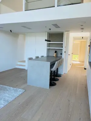 a kitchen with a table and chairs in a room at Mase waterunits 6 & 7 in Maaseik