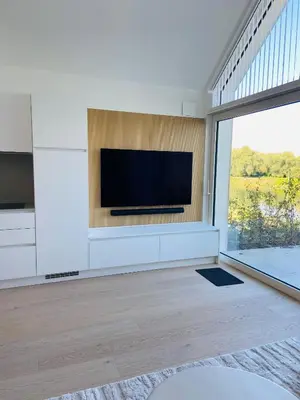 a living room with a flat screen tv on a wall at Mase waterunits 6 & 7 in Maaseik