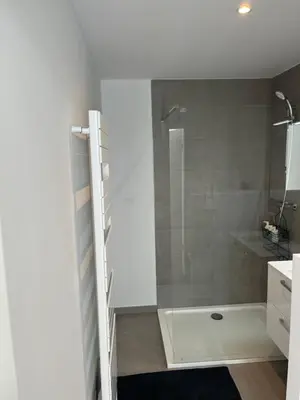 a bathroom with a shower with a glass door at Appart lumineux avec terrasse au cœur de Liège in Liège