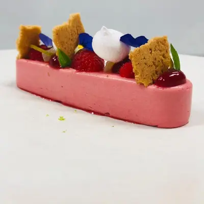 a pink dessert with berries and whipped cream on top at Charme logies Kampernoelie in Hoeselt