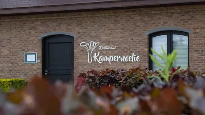 a sign on the side of a brick building at Charme logies Kampernoelie in Hoeselt