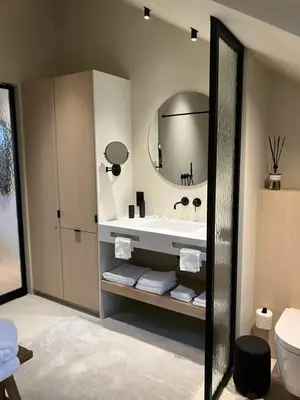 a bathroom with a tub and a sink and a mirror at Het Huisje in Tongeren