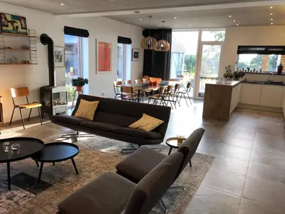 a living room with a couch and a table at Vakantiewoning De Vliergeit in Limburg - Haspengouw in Hasselt