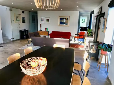 a living room with a black table and chairs at Vakantiewoning De Vliergeit in Limburg - Haspengouw in Hasselt