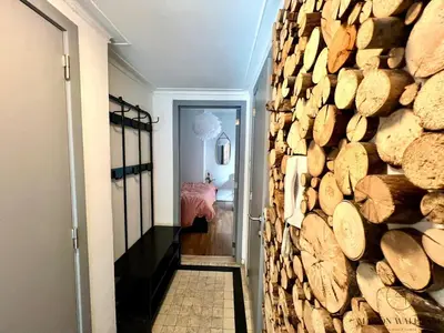a hallway with a wall of logs at Le Léopold - Cocon en Hypercentre de Liège in Liège