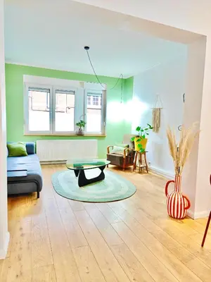 a living room with a couch and a table at Maison spacieuse, sereine proche du coeur de la ville et de la gare in Liège