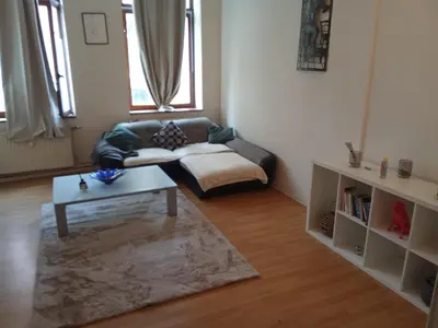 a living room with a couch and a coffee table at Night in Liège