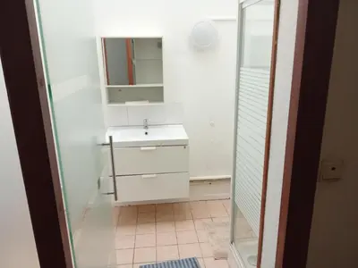 a white bathroom with a sink and a mirror at Night in Liège