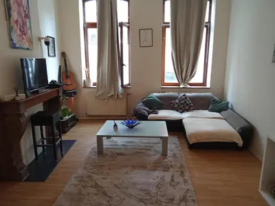 a living room with a couch and a coffee table at Night in Liège