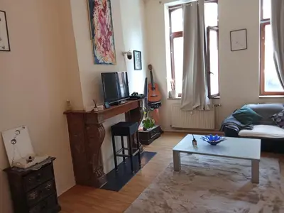 a living room with a couch and a table at Night in Liège