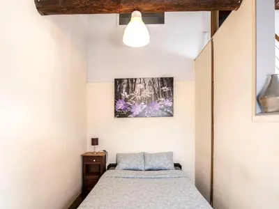 a bedroom with a bed and a picture on the wall at Farmhouse with garden and wellness in Heers