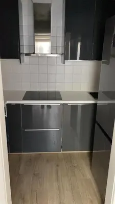 a kitchen with black and stainless steel cabinets at Residentie Ons Genoegen in Lommel