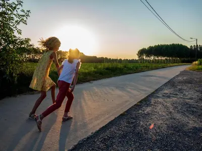 two children are walking down a road at Apartment with a view of alpacas in Heers