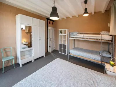 a room with two bunk beds and a chair at Holiday home with garden and roofed terrace in Heers