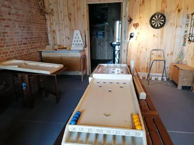 a room with two ping pong tables in it at Holiday home with garden and roofed terrace in Heers