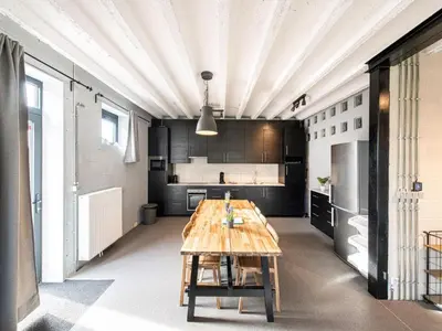 a large kitchen with a wooden table in a room at Holiday home with garden and roofed terrace in Heers