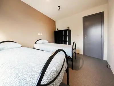 a bedroom with two beds and a closet at Single-storey holiday home in Heers in Heers