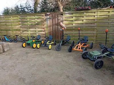 a group of tricycles parked next to a fence at Single-storey holiday home in Heers in Heers