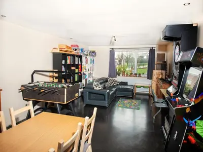 a living room with a table and a game console at Single-storey holiday home in Heers in Heers