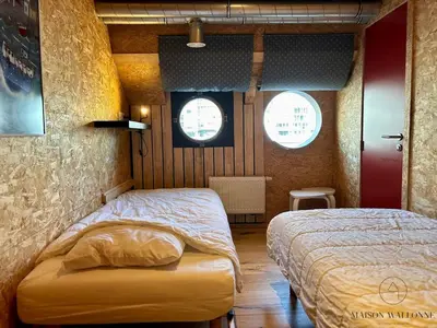 a bedroom with two beds and two windows at La péniche de Santa Cruz - Sur la Meuse, centre ville in Liège