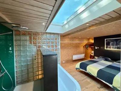 a bathroom with a bed and a bath tub in a room at La péniche de Santa Cruz - Sur la Meuse, centre ville in Liège