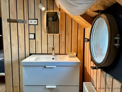 a bathroom with a sink and a mirror at La péniche de Santa Cruz - Sur la Meuse, centre ville in Liège