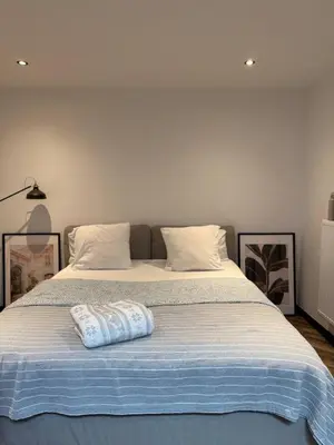a bed with a pillow on top of it at Premium apartment at the gates of Liège in Liège