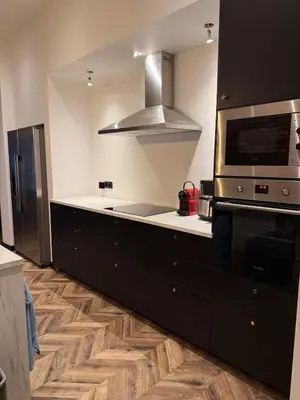 a kitchen with a stove and a microwave at Premium apartment at the gates of Liège in Liège