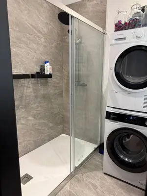 a washer and dryer next to a washing machine at Premium apartment at the gates of Liège in Liège