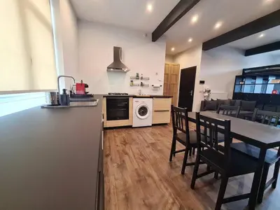 a kitchen and living room with a table and chairs at Elegant loft in Liège with private terrace in Mellet