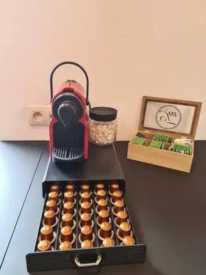 a red blender sitting next to a tray of cupcakes at Elegant loft in Liège with private terrace in Mellet