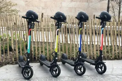 three scooters are parked next to a fence at Elegant loft in Liège with private terrace in Mellet
