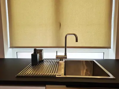 a kitchen counter with a sink and aounter at Elegant loft in Liège with private terrace in Mellet