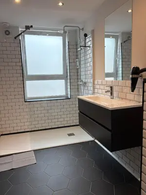 a bathroom with a sink and a large window at Elegance and sweetness of life in Liège in Liège