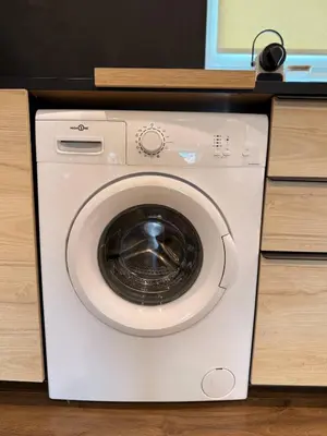 a white washing machine sitting in a cabinet at Elegance and sweetness of life in Liège in Liège