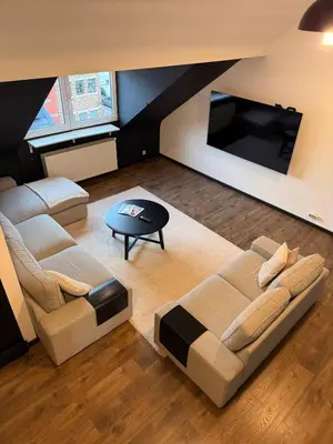 a living room with two couches and a table at Elegance and sweetness of life in Liège in Liège