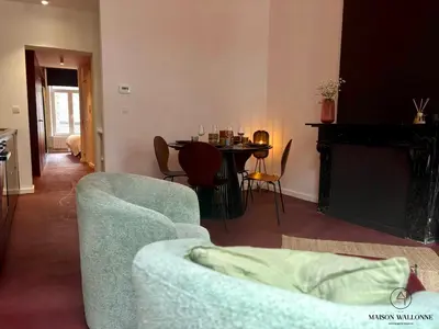 a living room with a couch and a table at Le Red Velvet - Hypercentre, pour 2 personnes in Liège