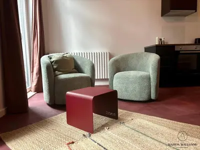 a living room with two chairs and a stool at Le Red Velvet - Hypercentre, pour 2 personnes in Liège