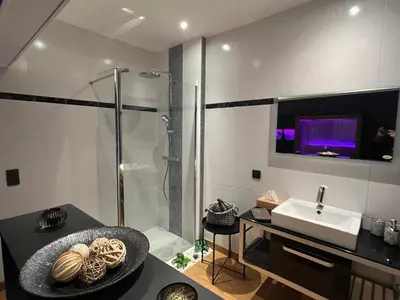 a bathroom with a shower and a sink at Pause Thermale Suite in Herstal