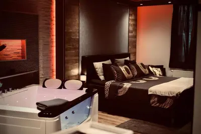 a bedroom with a bed and a bath tub at Pause Thermale Suite in Herstal
