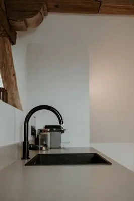 a kitchen counter with a sink in a kitchen at Molhemhoeve in Peer