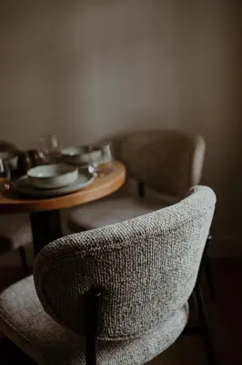 a dining room table with a chair and a table with plates at Molhemhoeve in Peer