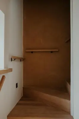 a room with a staircase with wooden shelves at Molhemhoeve in Peer