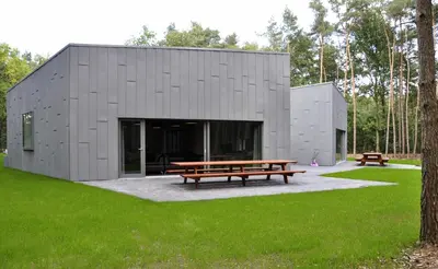 a building with a picnic table in a park at Twinstone Lodge in Genk